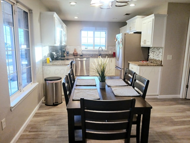 dining room with a chandelier and light wood-type flooring