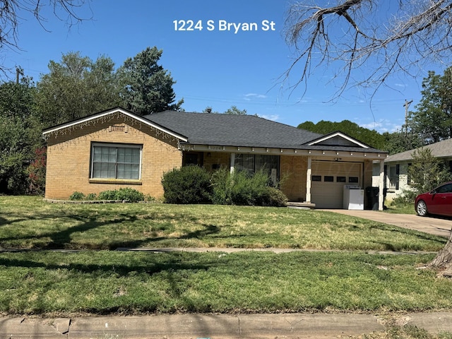 single story home with a garage and a front lawn