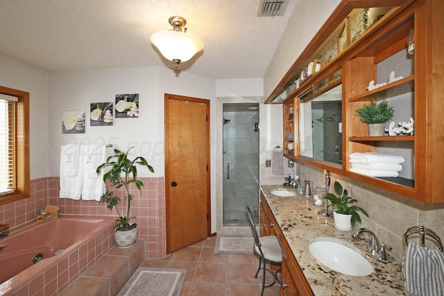 3508 Reeder Dr, Amarillo, TX 79121 - bathroom with visible vents, a bath, a sink, tile walls, and a shower stall
