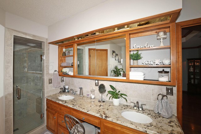 3508 Reeder Dr, Amarillo, TX 79121 - bathroom with a sink, decorative backsplash, a shower stall, and double vanity