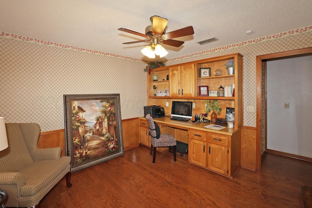 3508 Reeder Dr, Amarillo, TX 79121 - office area featuring visible vents, built in desk, a textured ceiling, wallpapered walls, and a wainscoted wall