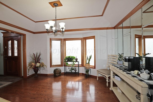 3508 Reeder Dr, Amarillo, TX 79121 - foyer entrance featuring wood finished floors, a notable chandelier, ornamental molding, and baseboards