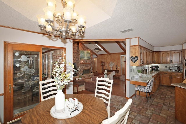 3508 Reeder Dr, Amarillo, TX 79121 - dining area with an inviting chandelier, a textured ceiling, visible vents, lofted ceiling, and a toaster