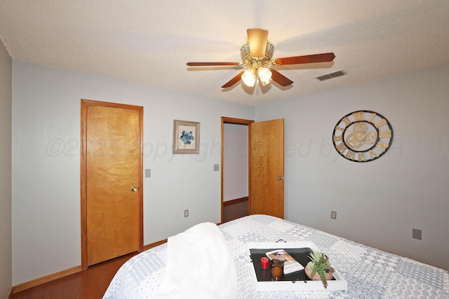 3508 Reeder Dr, Amarillo, TX 79121 - bedroom with baseboards, a textured ceiling, visible vents, ceiling fan, and wood finished floors