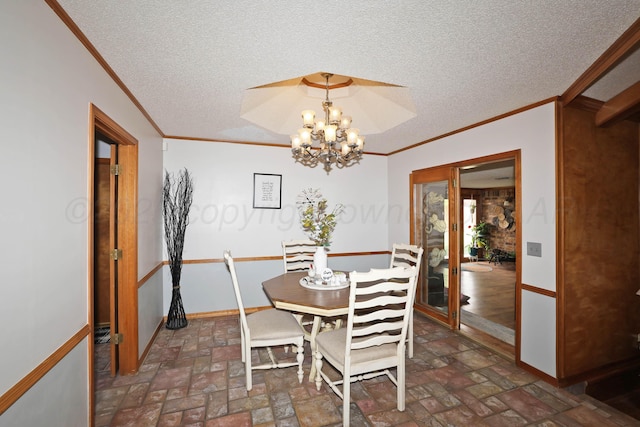 3508 Reeder Dr, Amarillo, TX 79121 - dining room with baseboards, a textured ceiling, an inviting chandelier, and crown molding