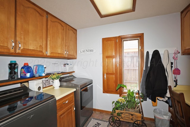3508 Reeder Dr, Amarillo, TX 79121 - washroom featuring a wealth of natural light, baseboards, washing machine and clothes dryer, and cabinet space