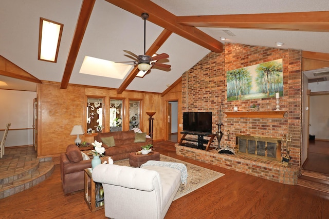 3508 Reeder Dr, Amarillo, TX 79121 - living area featuring vaulted ceiling with skylight, wood finished floors, ceiling fan, and a brick fireplace