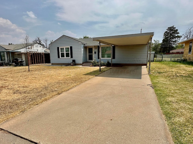 view of front of property with a carport and a front lawn