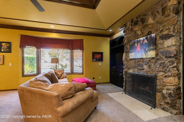 carpeted living room with ornamental molding, a fireplace, and a raised ceiling