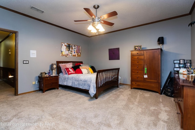 carpeted bedroom with crown molding, a textured ceiling, and ceiling fan