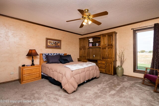 bedroom featuring crown molding, ceiling fan, carpet, and a textured ceiling