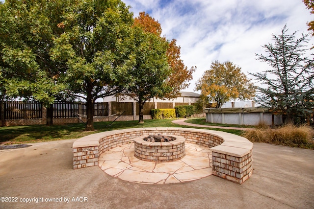 view of patio / terrace with a covered pool and an outdoor fire pit