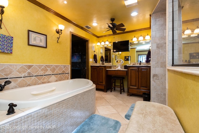 bathroom featuring crown molding, tile patterned floors, vanity, and tiled tub