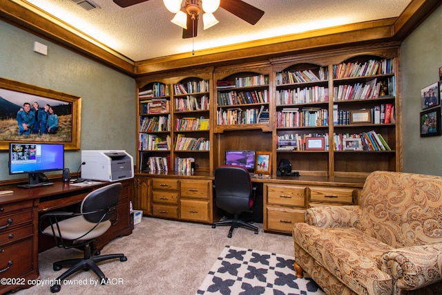 carpeted office featuring ceiling fan and a textured ceiling