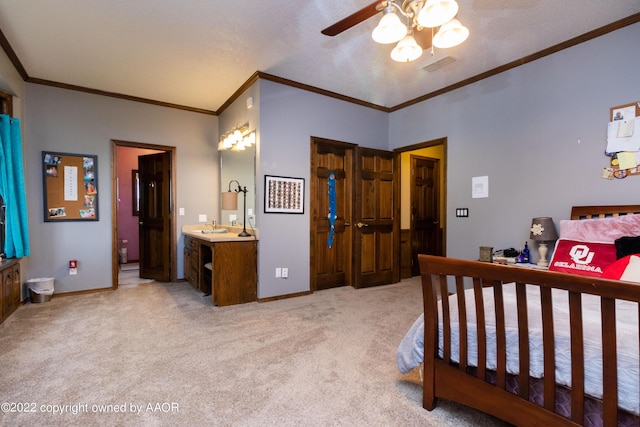 bedroom featuring sink, crown molding, light colored carpet, and ceiling fan