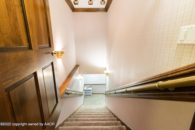 staircase featuring ornamental molding