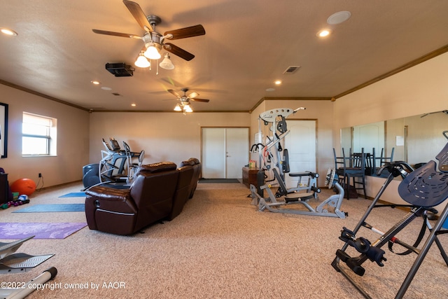 gym with ornamental molding and carpet flooring