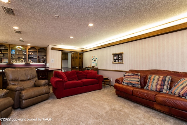 carpeted living room with built in shelves and a textured ceiling