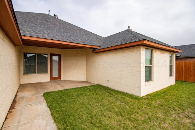 8303 City View Dr, Amarillo, TX 79118 - rear view of house featuring a shingled roof, brick siding, and a patio