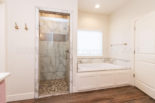 8303 City View Dr, Amarillo, TX 79118 - full bathroom featuring a bath, wood tiled floors, a marble finish shower, vanity, and recessed lighting