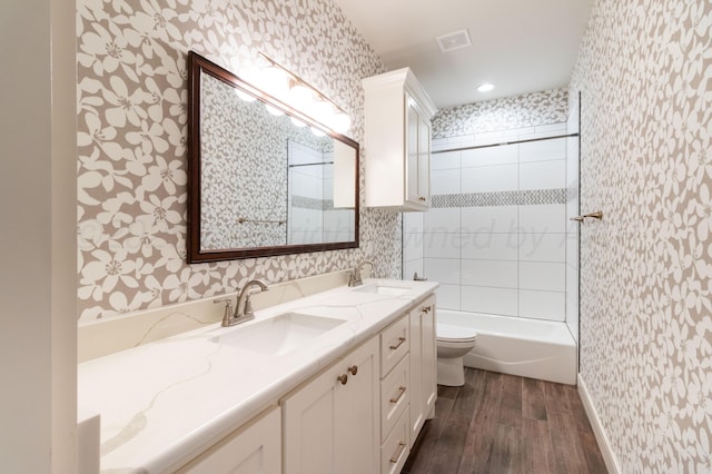 8303 City View Dr, Amarillo, TX 79118 - full bath featuring wallpapered walls, wood finished floors, toilet, double vanity, and bathtub / shower combination