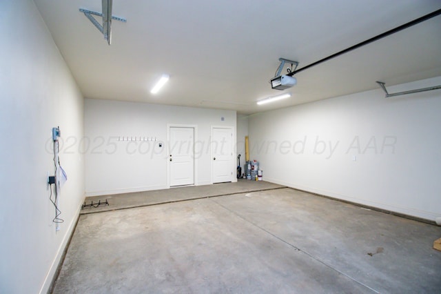 8303 City View Dr, Amarillo, TX 79118 - garage featuring a garage door opener and baseboards