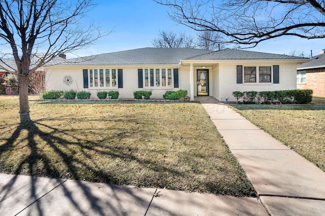 ranch-style home with brick siding and a front yard