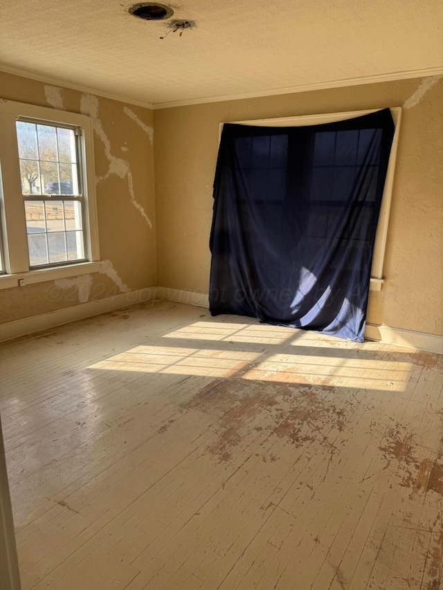 811 S Palo Duro St, Amarillo, TX 79106 - unfurnished room with wood-type flooring, crown molding, and a textured ceiling