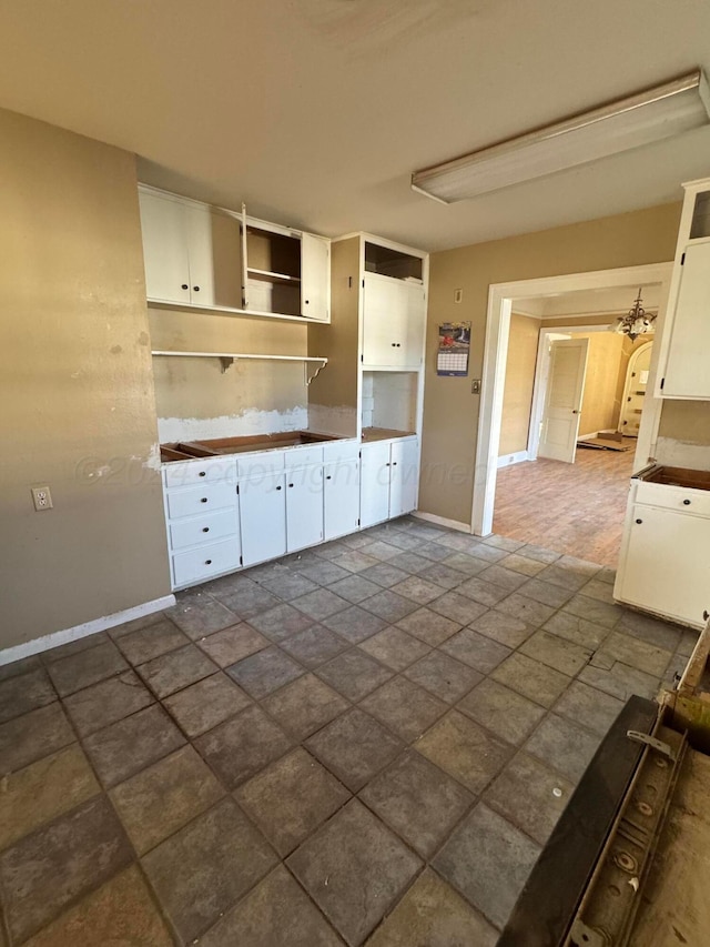 811 S Palo Duro St, Amarillo, TX 79106 - kitchen with stone finish floors, white cabinets, and open shelves