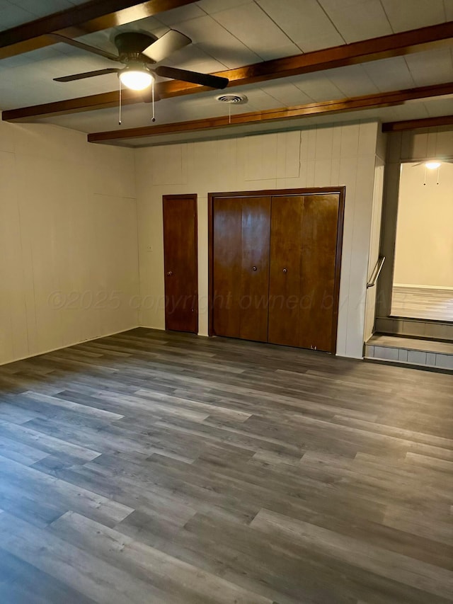 408 Jupiter St, Pampa, TX 79065 - unfurnished bedroom with beamed ceiling, wood finished floors, and multiple closets
