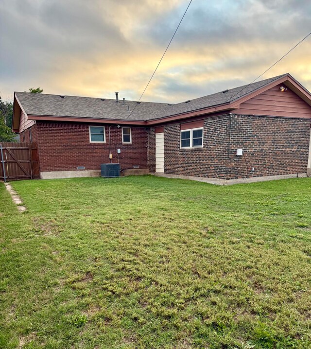 408 Jupiter St, Pampa, TX 79065 - rear view of property featuring brick siding, cooling unit, and roof with shingles