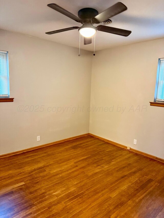 408 Jupiter St, Pampa, TX 79065 - empty room with wood finished floors, a ceiling fan, and baseboards