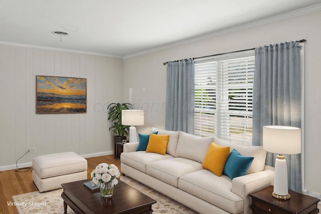 living area featuring wood finished floors, ornamental molding, and baseboards