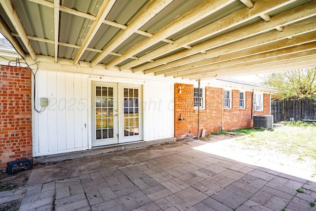 view of patio / terrace featuring french doors, central AC, and fence