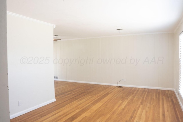 unfurnished room featuring light wood-type flooring, crown molding, and baseboards