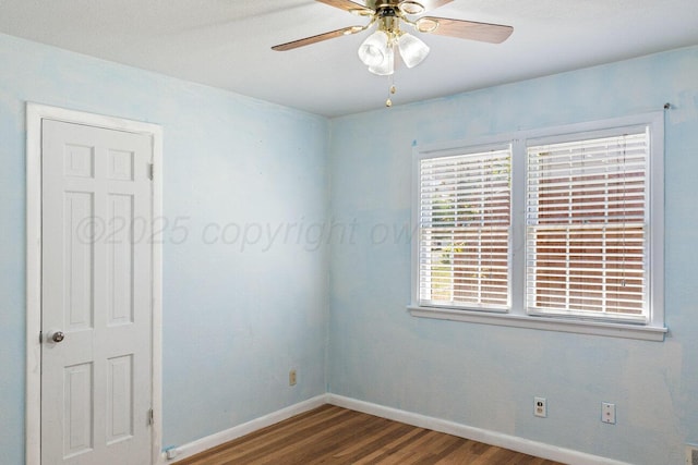 unfurnished room featuring wood finished floors, baseboards, and a ceiling fan
