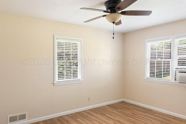 unfurnished room with light wood-type flooring, baseboards, a ceiling fan, and cooling unit