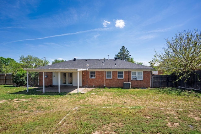 rear view of house with french doors, a patio area, brick siding, and central AC unit