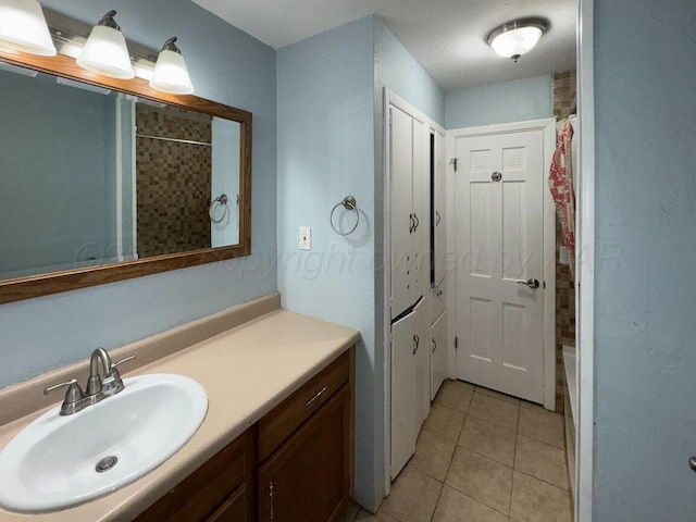 full bath with vanity and tile patterned flooring