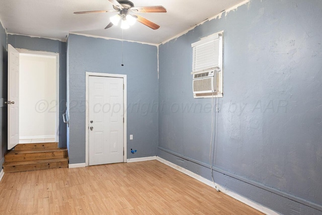unfurnished room with light wood-type flooring, ceiling fan, and baseboards