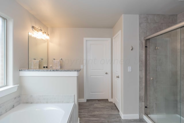 1839 Montaluse Rd, Amarillo, TX 79118 - full bathroom with a shower stall, a garden tub, wood finished floors, and vanity