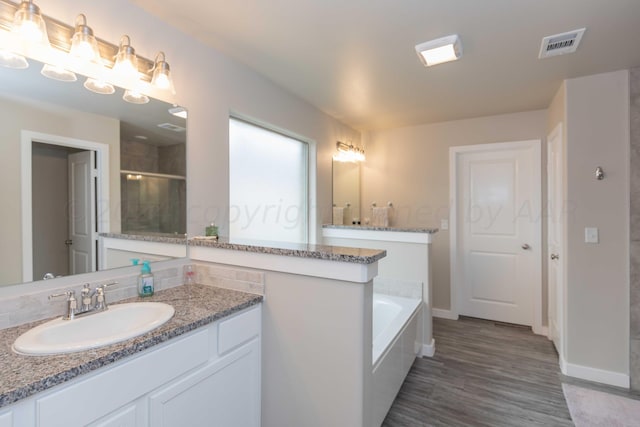 1839 Montaluse Rd, Amarillo, TX 79118 - bathroom featuring vanity, a bath, wood finished floors, and a shower with shower door