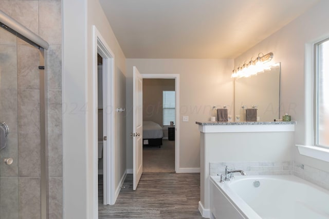 1839 Montaluse Rd, Amarillo, TX 79118 - full bath with ensuite bath, a garden tub, wood finished floors, a tile shower, and healthy amount of natural light
