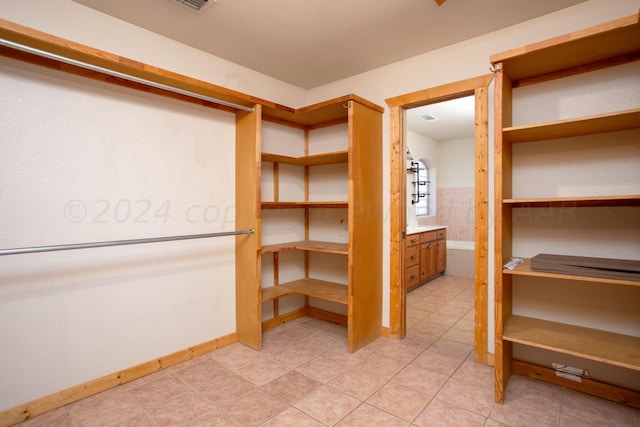 walk in closet featuring light tile patterned floors