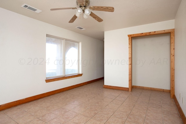 unfurnished bedroom with ceiling fan and light tile patterned floors