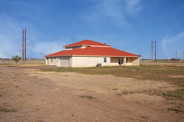 view of home's exterior with a garage and cooling unit