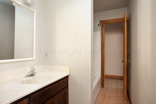 bathroom featuring vanity, tile patterned flooring, and washtub / shower combination