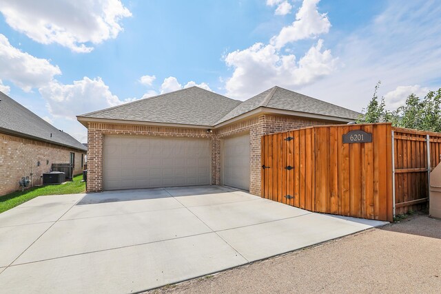 6201 Bay Rdg, Amarillo, TX 79119 - view of front of house with brick siding, a shingled roof, a garage, and concrete driveway