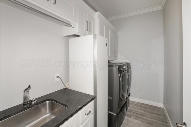 6201 Bay Rdg, Amarillo, TX 79119 - washroom with separate washer and dryer, cabinet space, crown molding, and wood finished floors