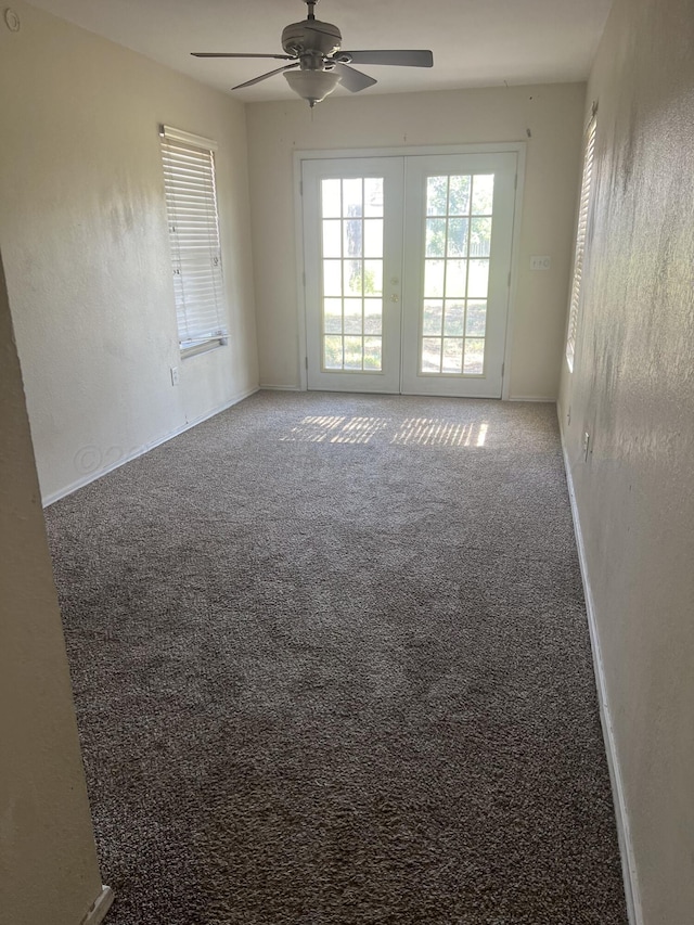 unfurnished room with ceiling fan, french doors, and carpet